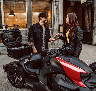 Couple laughing next to LinQ thermal box on Can-Am Ryker vehicle with adrenaline red panels Couple laughing next to LinQ thermal box on Can-Am Ryker vehicle with adrenaline red panels